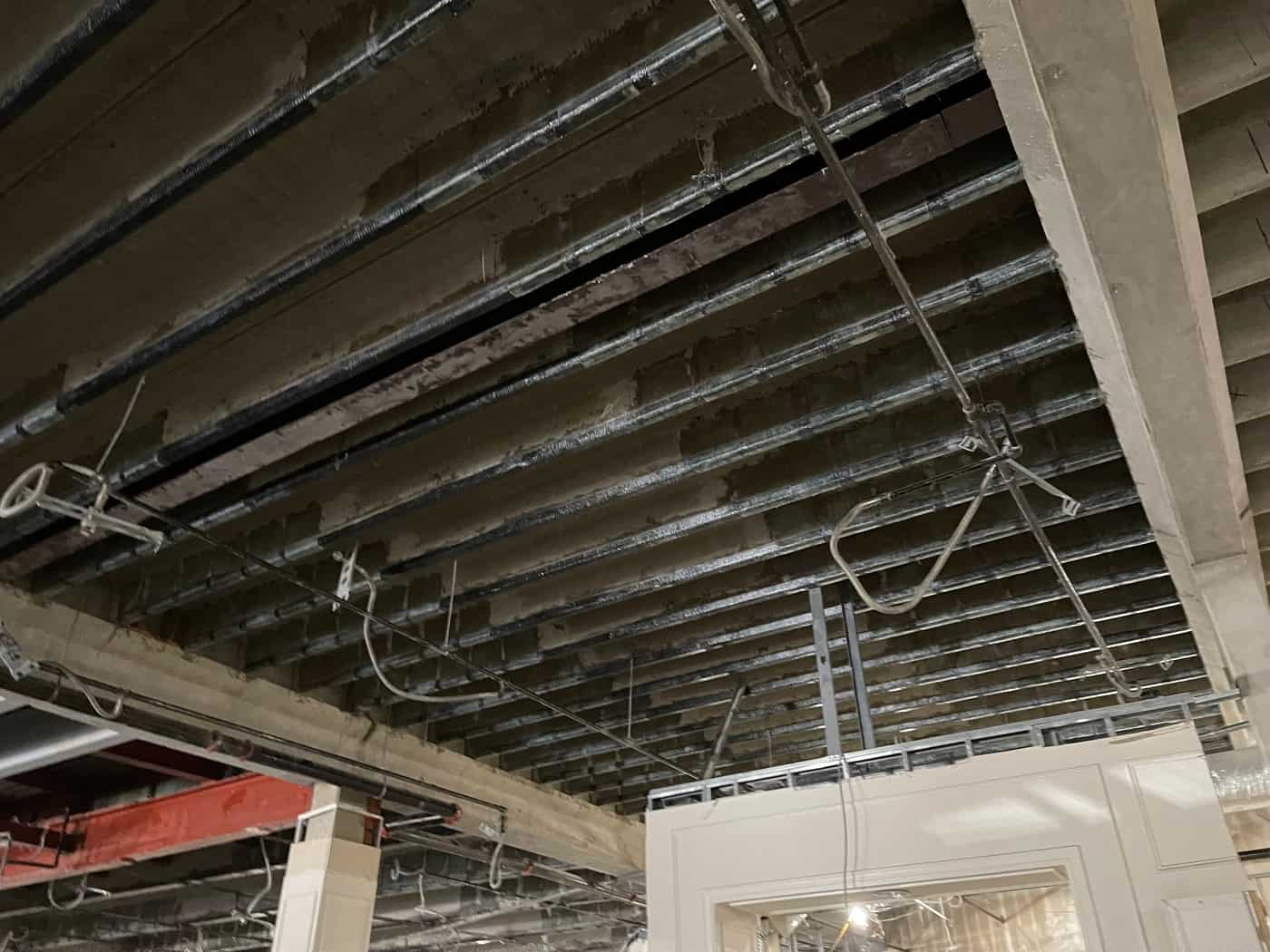 Wide view of joist soffits with long carbon fiber strips and a girder.