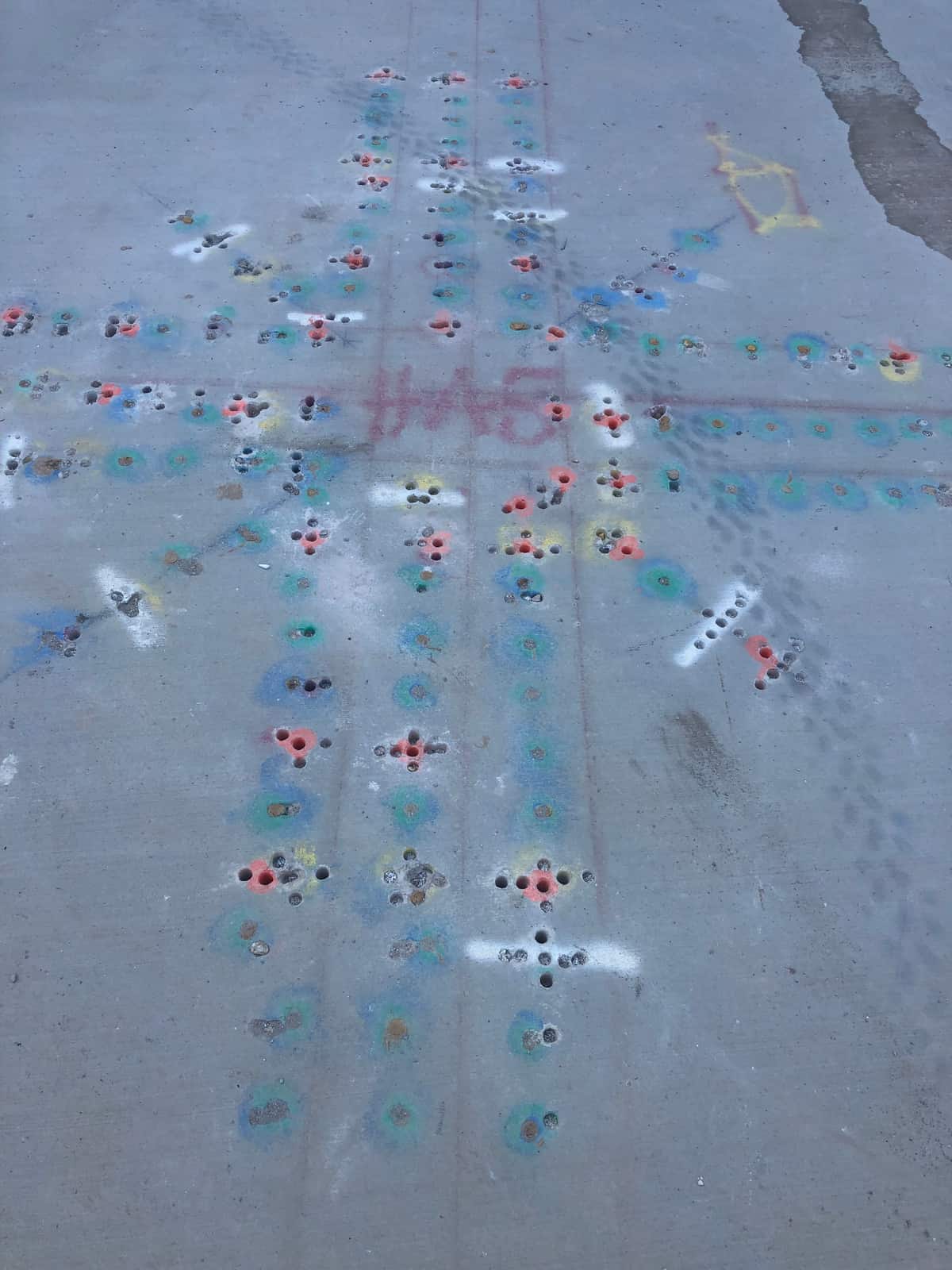 Slab top with color-coded scan marks and drilled hole layout radiating from a column.