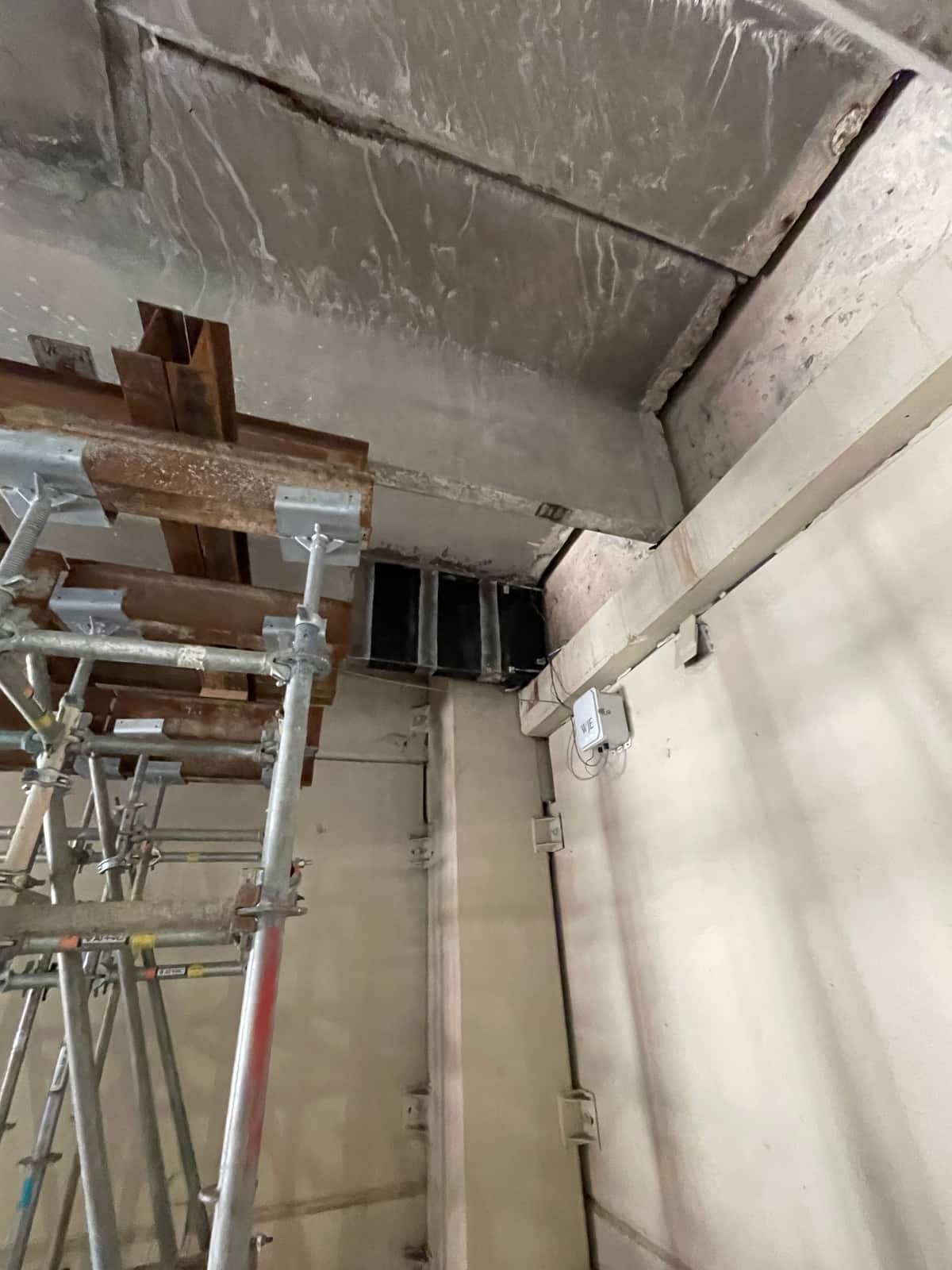 Shoring at left and carbon fiber strips at a beam-to-wall junction.