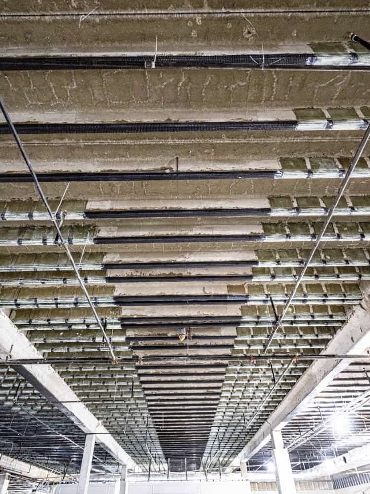 Joist ceiling with carbon fiber strips and ceiling grid framing.